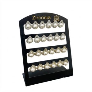 Large heart-shaped earrings with stones displayed on a stand