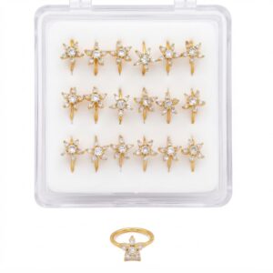 Elegant gold nose rings with flower design and stones in a display case